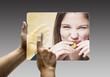 hands reaching images on a futuristic tablet
