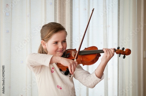 Photo: Child playing violin indoors Child playing violin indoors