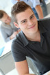 Portrait of cheerful student boy in class