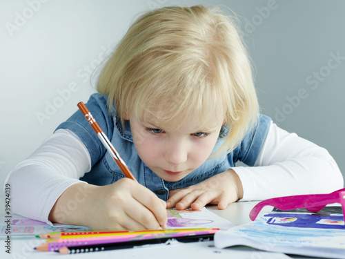 Photo: Cute child concentrated is painting a picture Cute child concentrated is painting a picture
