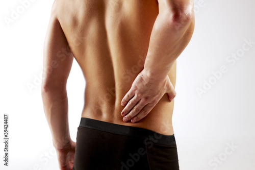 Photo: Young man with back pain Young man with back pain