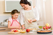 Mother and daughter cutting apples for pie