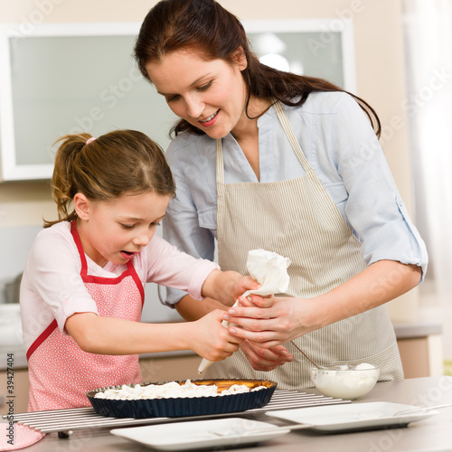Photo: Decorating cake mother and daughter Decorating cake mother and daughter