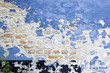 blue paint peeling brick wall