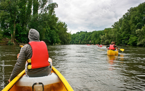 Photo: Tourists kayaking on river Dordogne in France Tourists kayaking on river Dordogne in France