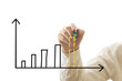 Businessman drawing bar graph with marker over white Businessman drawing bar graph with marker over white