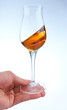 Photo: glass of brandy or whisky in the hand glass of brandy or whisky in the hand