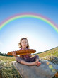 Child eating bread in wheat field