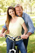 Photo: Couple with bike in park Couple with bike in park