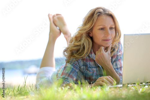 Photo: Woman on laptop outside Woman on laptop outside