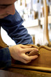 Young man sanding furniture
