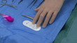 Surgeon preparing a stitching wire