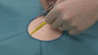 Surgeon  exercising stitching, finishing a stitch
