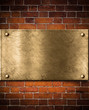 old golden or bronze plate on brick wall old golden or bronze plate on brick wall