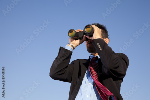Photo: Businessman searching with his binoculars Businessman searching with his binoculars