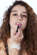 Woman applying lipstick