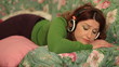 Redheaded woman uses an mp3 player