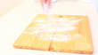 Female hands strew a flour on chopping board