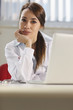 happy female doctor working with computer in studio