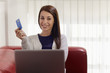 woman with laptop and credit card shopping on internet