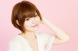 Beautiful young woman on pink background