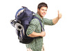 Portrait of a man with backpack giving thumb up