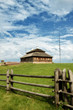 wooden cottage on green hill