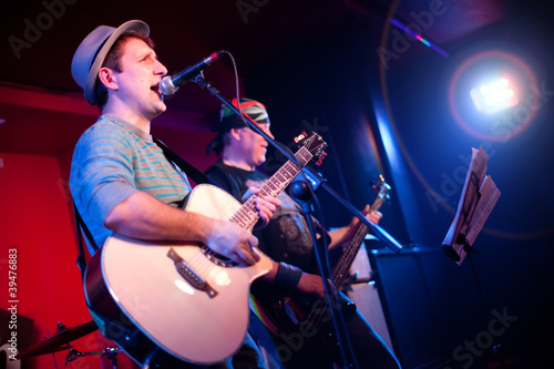 Photo: musician plays a guitar musician plays a guitar