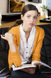 the girl reading a book, her elbow is resting on the book the girl reading a book, her elbow is resting on the book