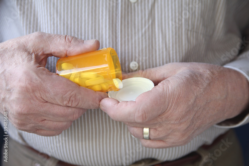 Photo: older man gets ready to take a pill older man gets ready to take a pill