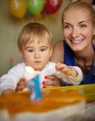 Happy mother with her baby celebrating birthday