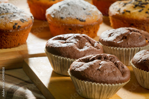 Photo: Chocolate and vanilla muffins on wooden board Chocolate and vanilla muffins on wooden board