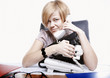 Photo: Portrait of business woman sitting at a desk in the office Portrait of business woman sitting at a desk in the office