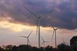 windmills on a hill at sunset with clouds