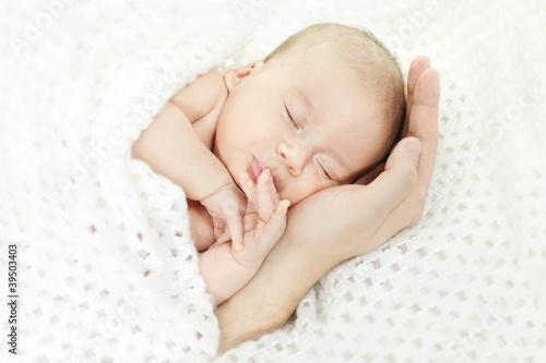 Photo: Newborn baby sleeping on parents hand Newborn baby sleeping on parents hand