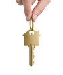 Human hand holding key to a dream house isolated on white