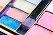 Multicolored eye shadows and cosmetics brush