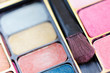 Multicolored eye shadows and cosmetics brush