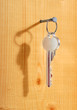 The key is hanging on a nail.