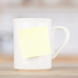 weiße kaffeetasse mit einem merkzettel