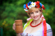 Ukrainian woman with a wooden mug
