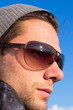 Brunette Man With Sunglasses And A Hat Looking