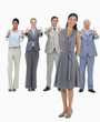 Laughing woman with a business team with their thumbs-up