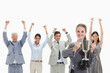 Close-up of a blonde woman holding a cup with enthusiastic business people behind her