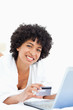 Portrait of a woman using a laptop for shopping
