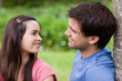 Young couple looking at each other while standing in the countryside