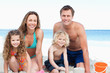 Family building a sandcastle on the beach