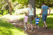 A happy family walking down a path