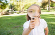 Girl outside with magnifying glass 