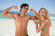 Young smiling woman touching her boyfriend's biceps